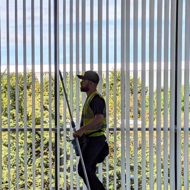 Raincom operative cleaning high glazing at Aldi in Swindon